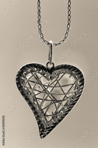 Slika na platnu Silver pedant in the shape of a heart