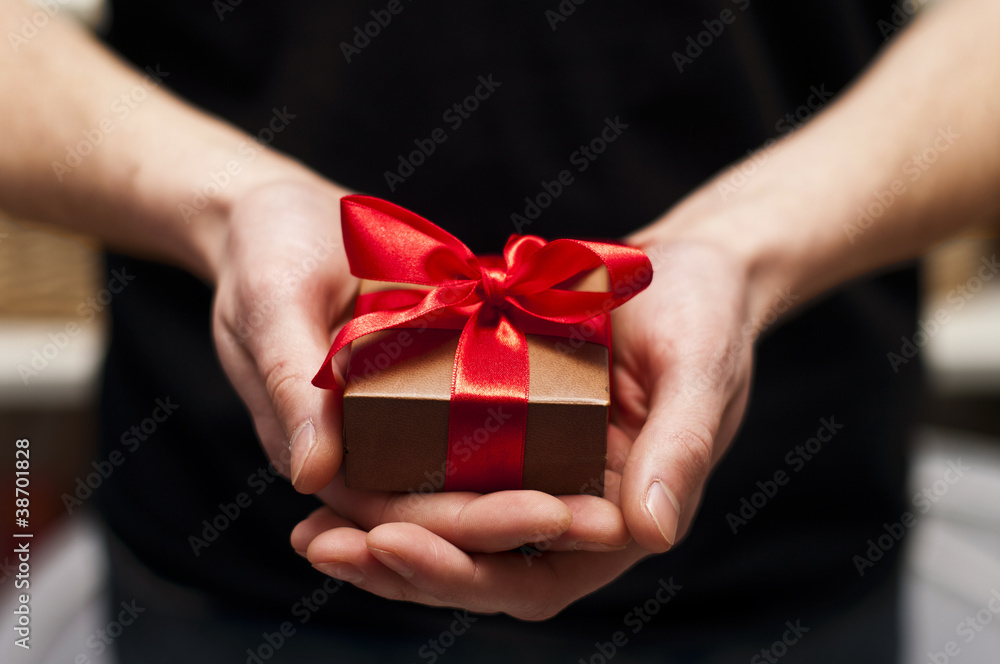 Men's hand holding gift box