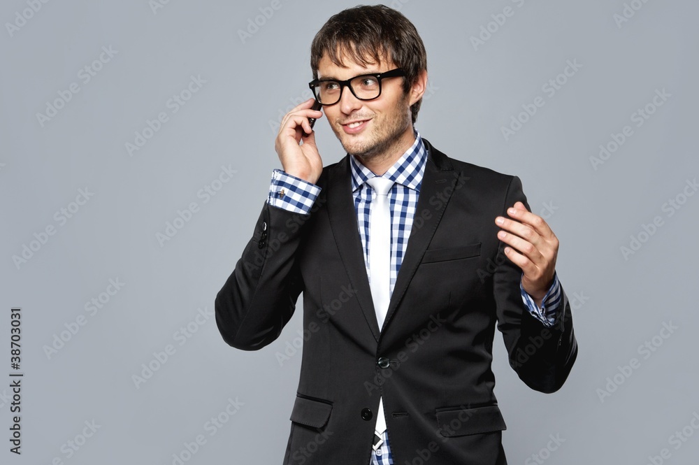 Handsome young man in glasses with mobile phone Handsome young man in glasses with mobile phone