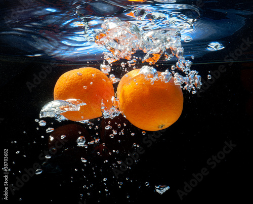 three oranges in water