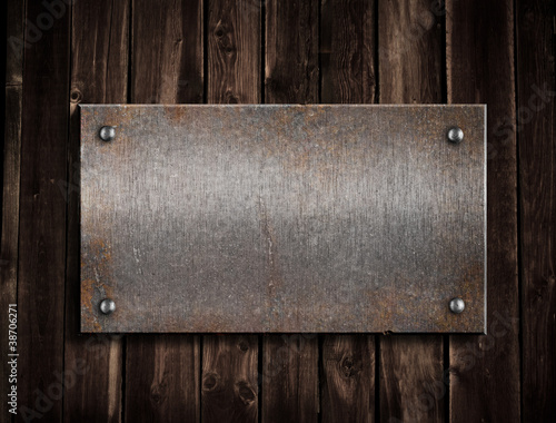rusty metal plate on wooden...