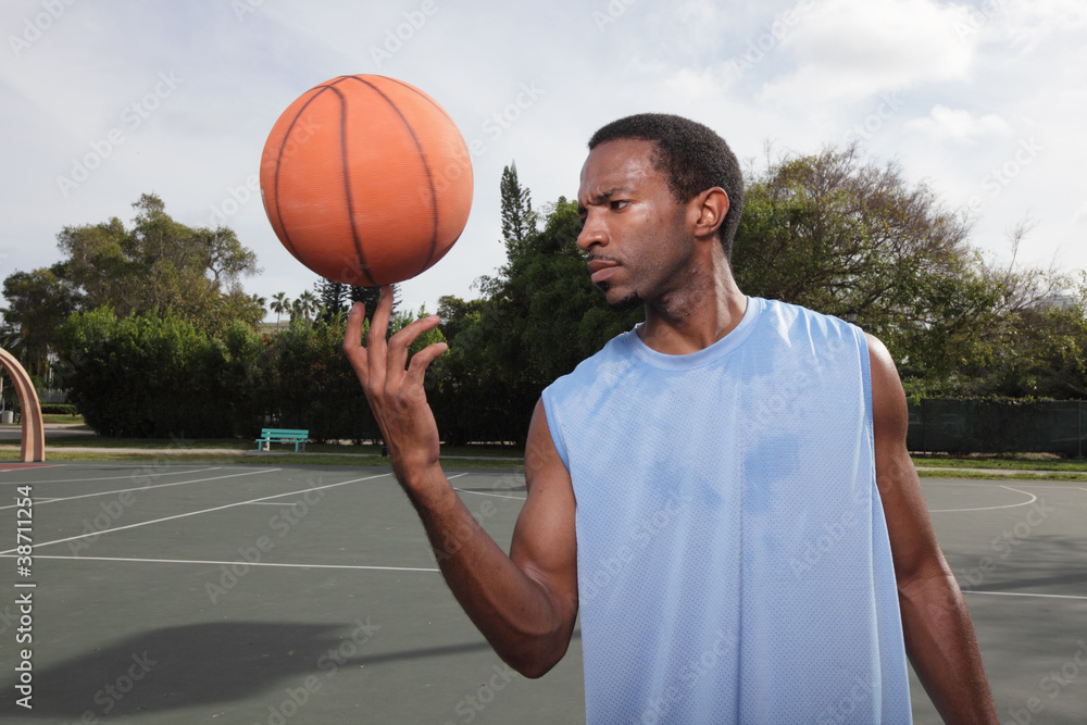 Fototapeta premium Basketball player spinning the ball