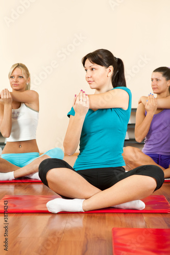 Women at the gym in a stretching class