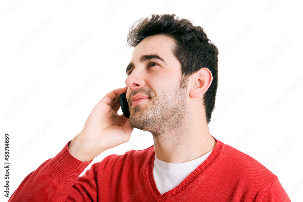 young casual man talking on the phone isolated on white backgrou young casual man talking on the phone isolated on white backgrou