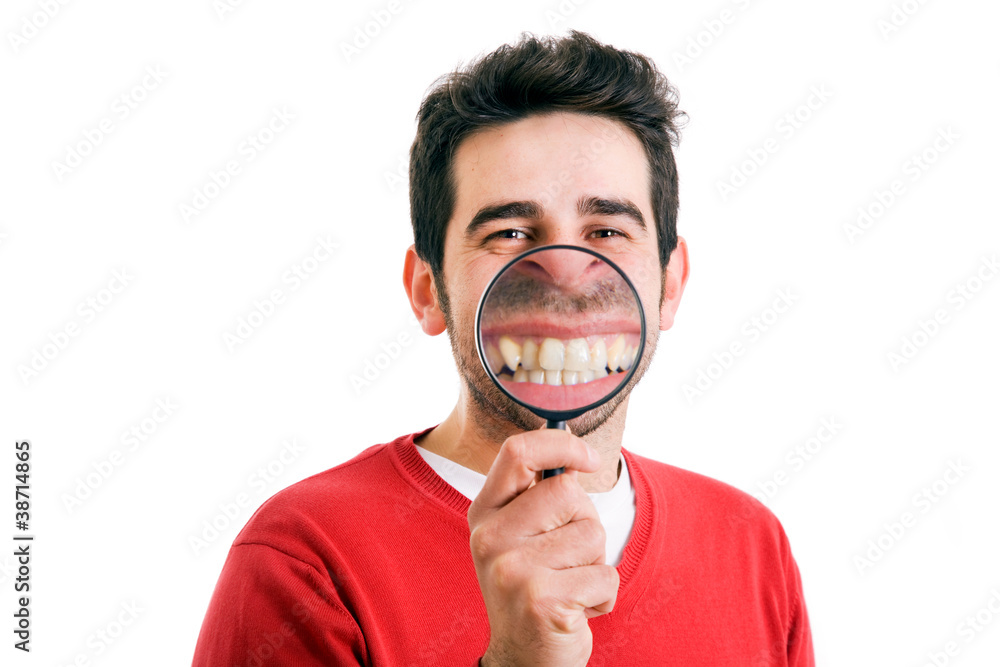 Funny image of a man with magnifying glass held up to face enlar Funny image of a man with magnifying glass held up to face enlar