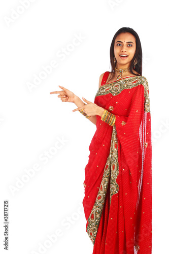 Young Indian girl in traditional clothing presenting.