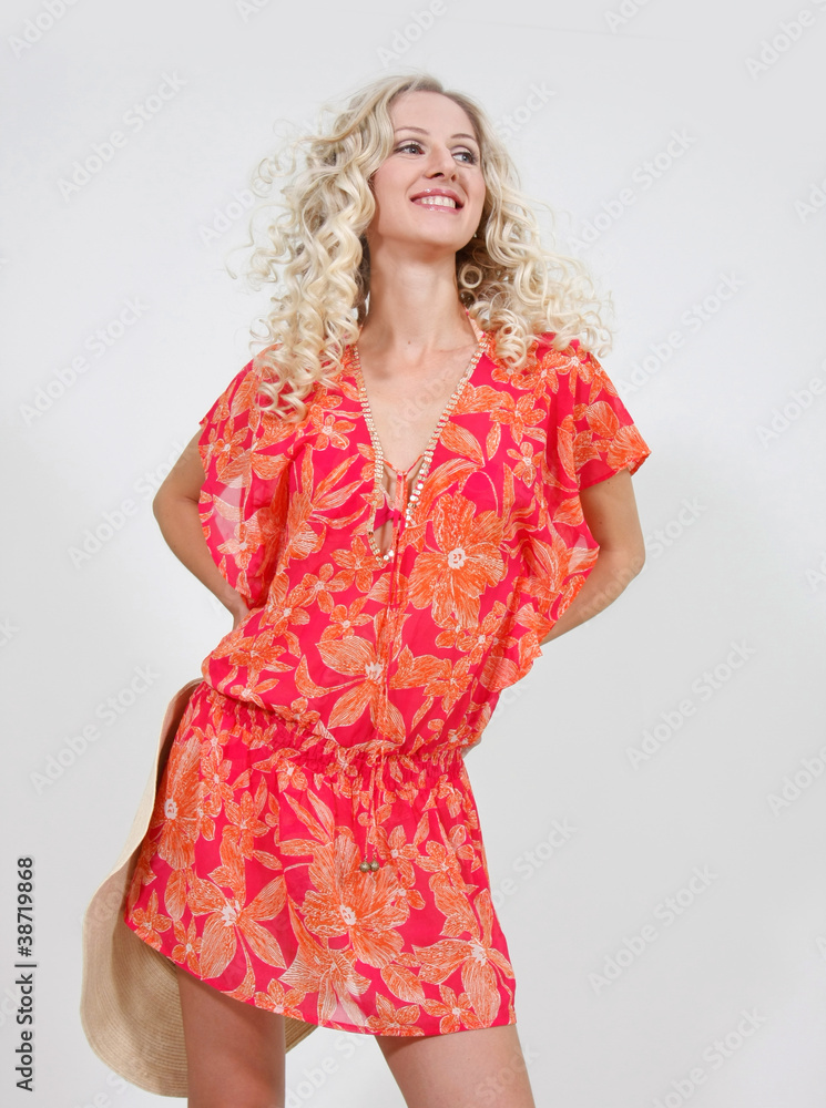 studio shot of young happy woman with summer hat
