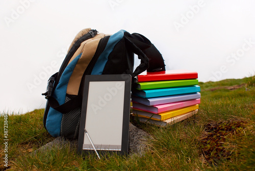 Obraz na płótnie Stack of colorful books and electronic book reader w salonie