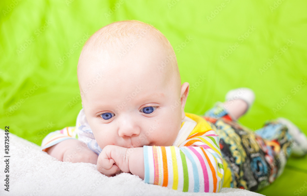 The thoughtful kid lies on a pillow. The thoughtful kid lies on a pillow.