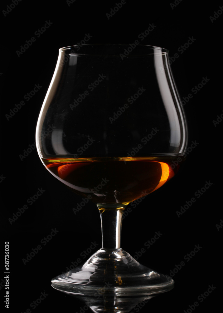 Glass of cognac on black background Glass of cognac on black background