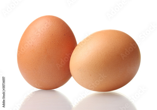 two brown eggs isolated on white