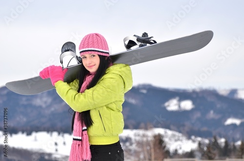 Woman holding snowboard