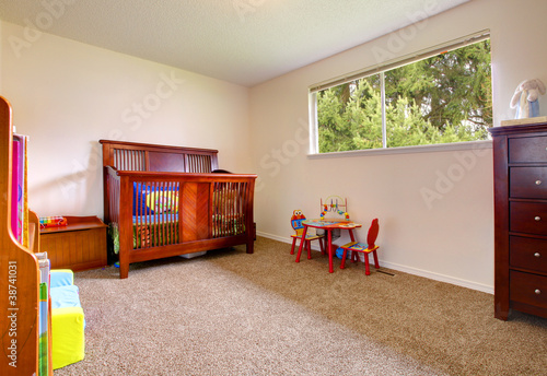 Simple baby room with wood crip photo