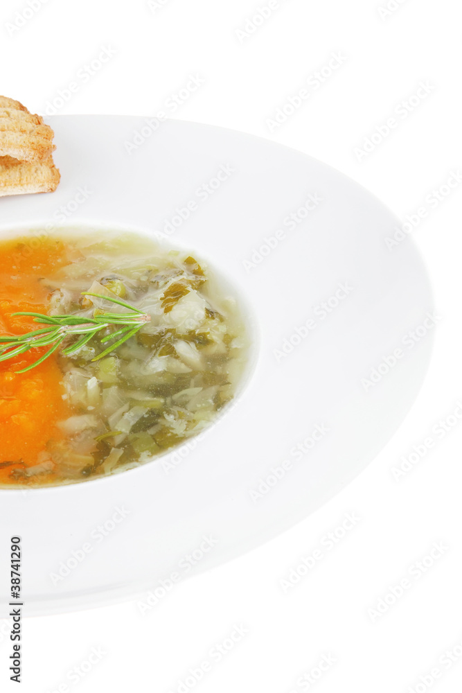 vegetable soup served with toasts on white dish