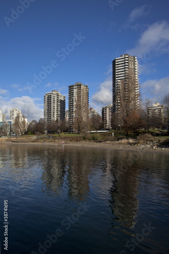 downtown highrises reflect off of english bay waters  vancouver