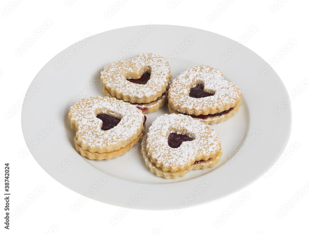 White plate with four heart shaped cookies White plate with four heart shaped cookies