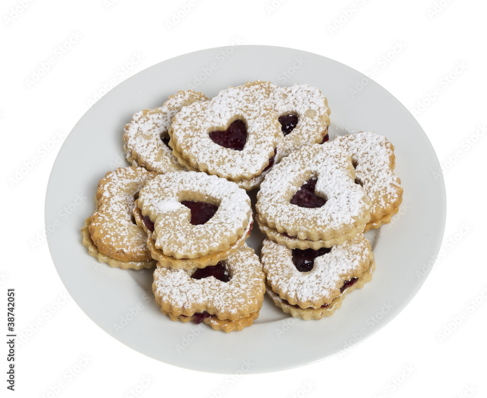 Plate of heart shaped cookies isolated on white