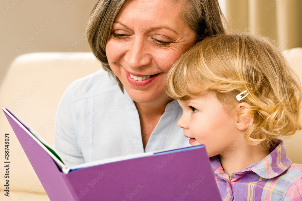 Grandmother and granddaughter read book together Grandmother and granddaughter read book together