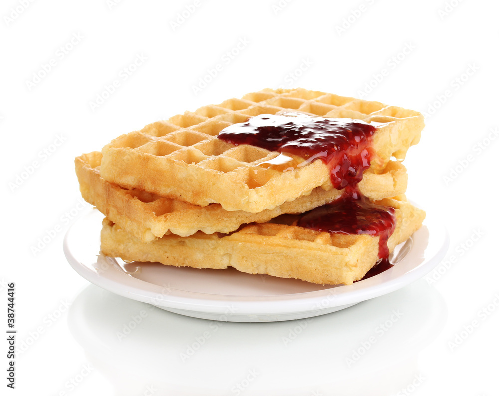 Tasty waffles with jam on plate isolated on white Tasty waffles with jam on plate isolated on white