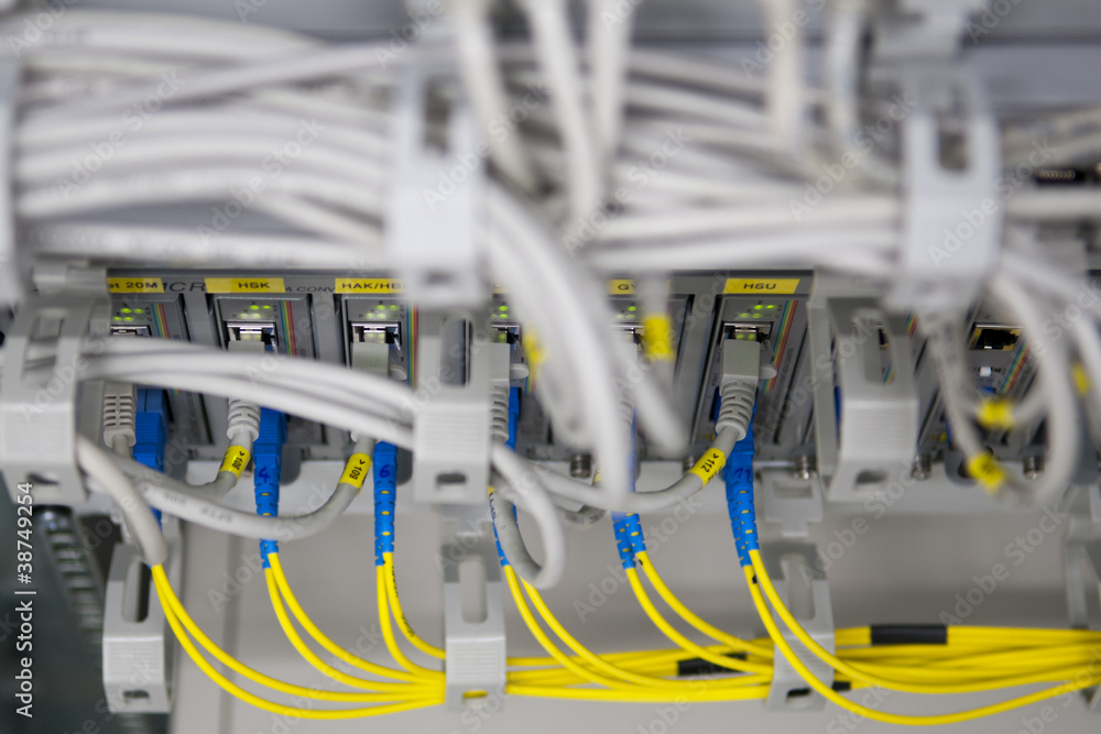 IT equipment with yellow fiber glass adapters to ethernet