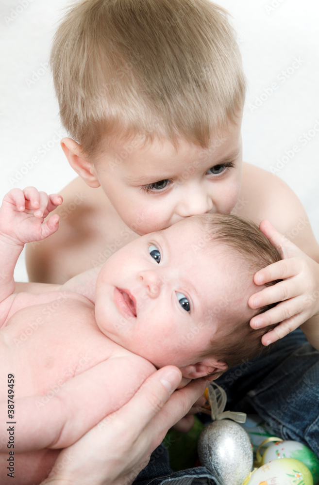 Little boy kiss her newborn sister Little boy kiss her newborn sister