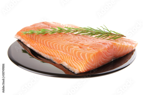 fresh raw salmon fillet on black with rosemary