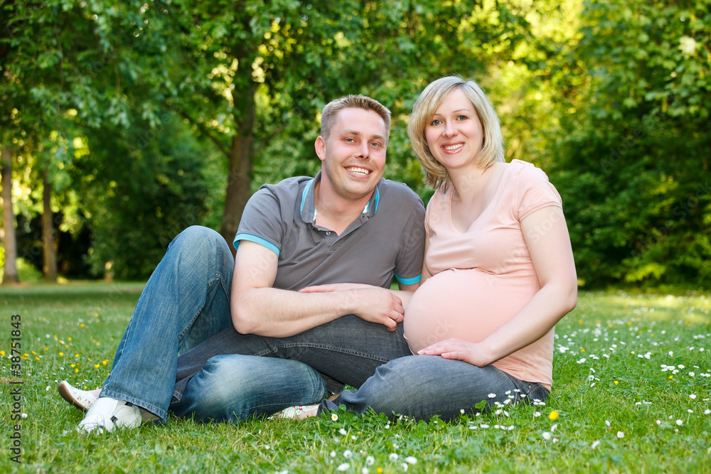 Pregnant couple in the park Pregnant couple in the park