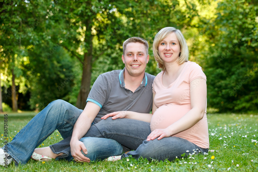 Pregnant couple in the park Pregnant couple in the park