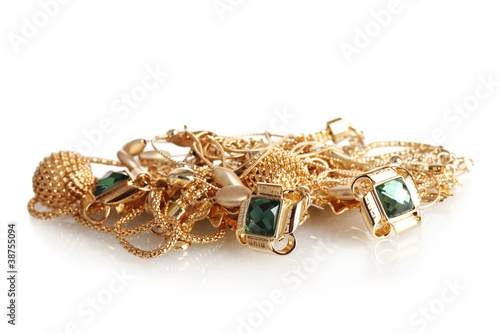 Various gold jewellery isolated on white