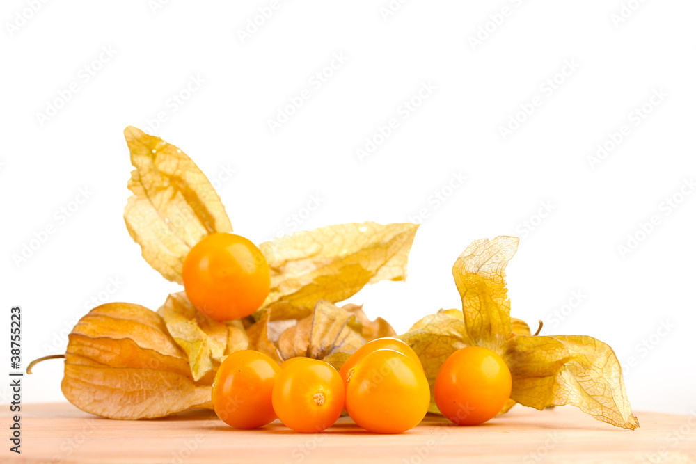 Physalis heap on wooden table on white background Physalis heap on wooden table on white background