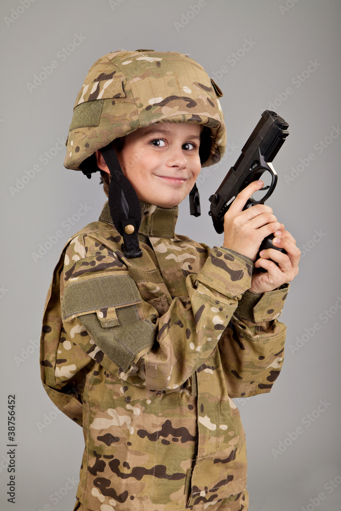 Young boy dressed like a soldier with a gun Young boy dressed like a soldier with a gun
