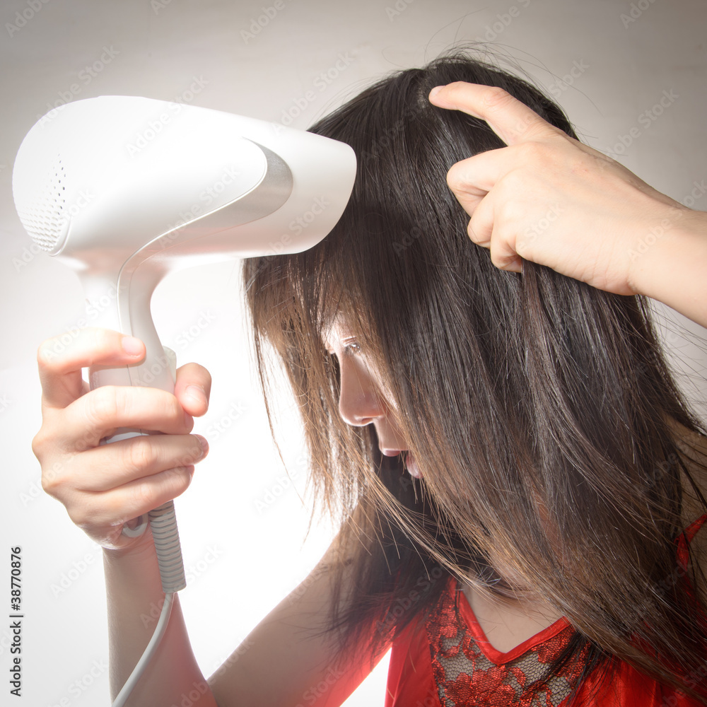 Fototapeta premium woman with hair blow drier