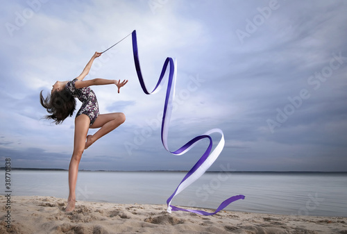 Young gymnast girl dance with ribbon