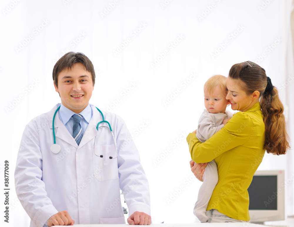 Fototapeta premium Portrait of pediatric doctor and mother with baby on examination