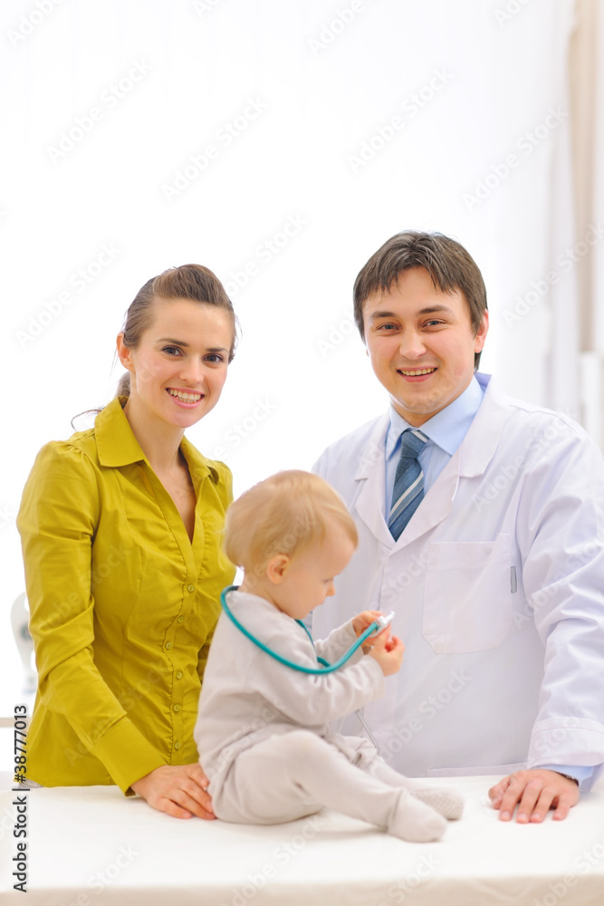 Pediatrician doctor and mother with baby on examination Pediatrician doctor and mother with baby on examination