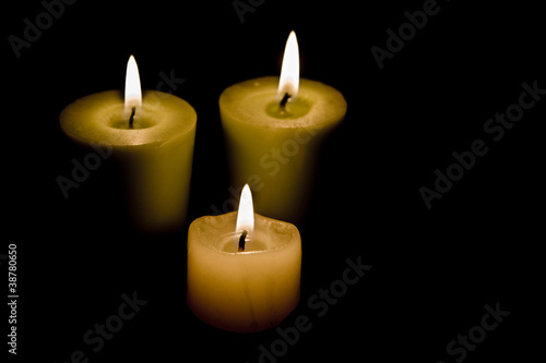 Three Candles on black background