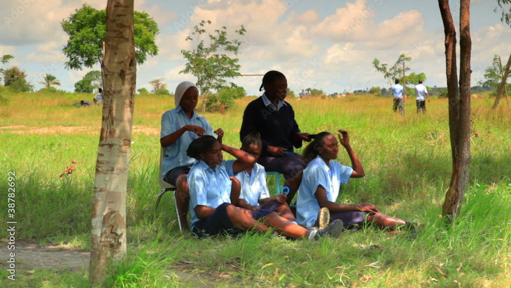 People taking a break in a village in Kenya. People taking a break in a village in Kenya.