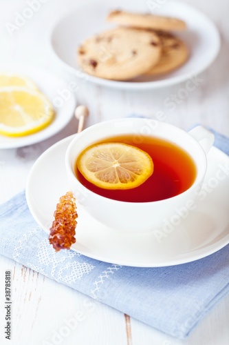 Cup of tea with lemon and sugar swizzle stick