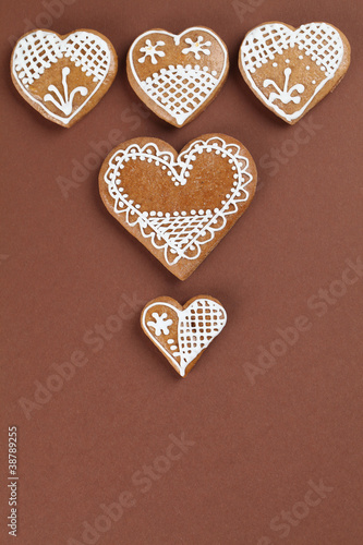 Gingerbread hearts on brown background