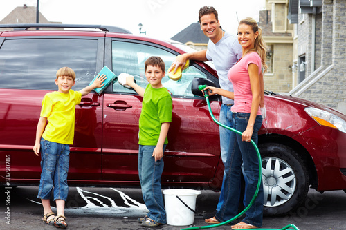 Happy family washing the family car. © grinny