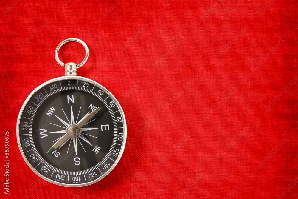 compass on the vivid red background compass on the vivid red background