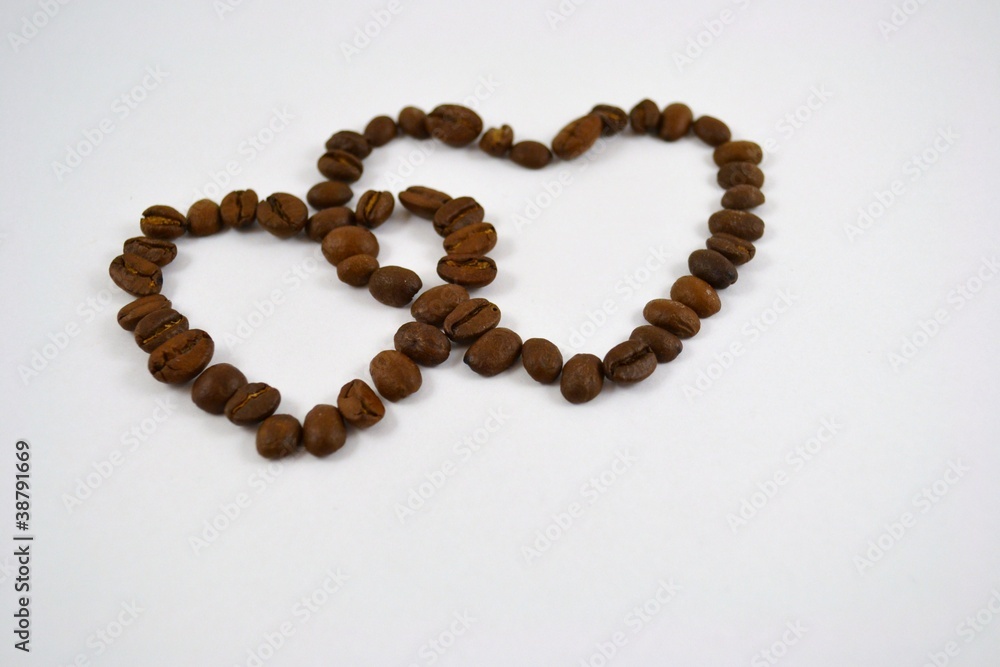 Two hearts from coffee grains are connected together Two hearts from coffee grains are connected together