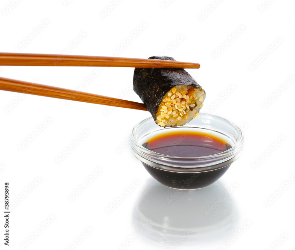 Dipping roll in sauce isolated on white Dipping roll in sauce isolated on white