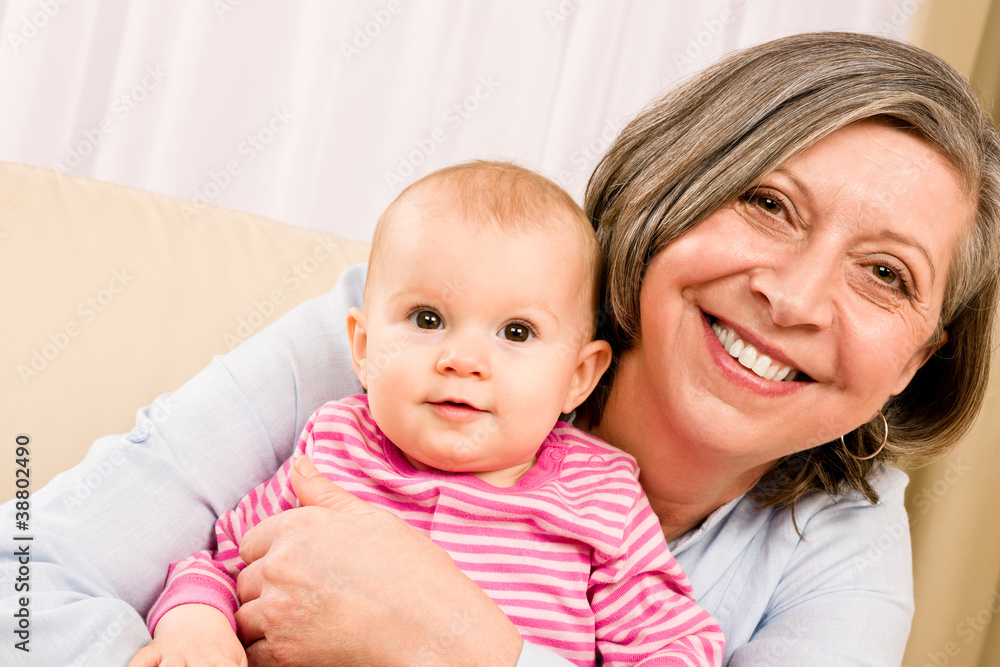 Grandmother hold little baby girl smiling