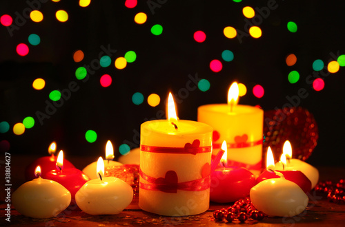 Beautiful candles on wooden table on bright background