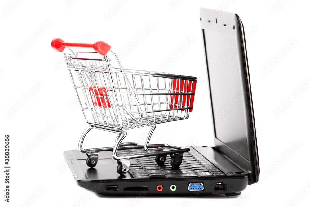 Online shopping. Shopping cart with notebook on the white.