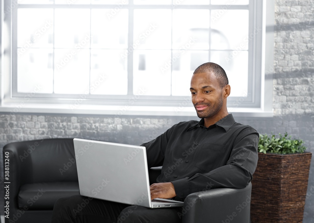 Businessman working in armchair Businessman working in armchair
