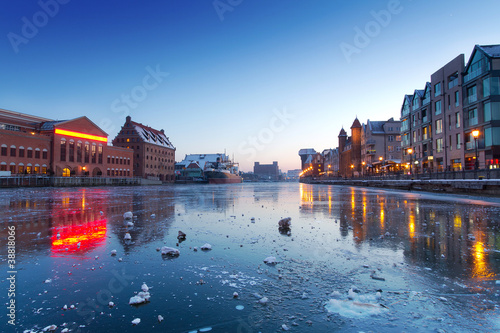 Old town in Gdansk with frozen Motlawa river at dusk, Poland