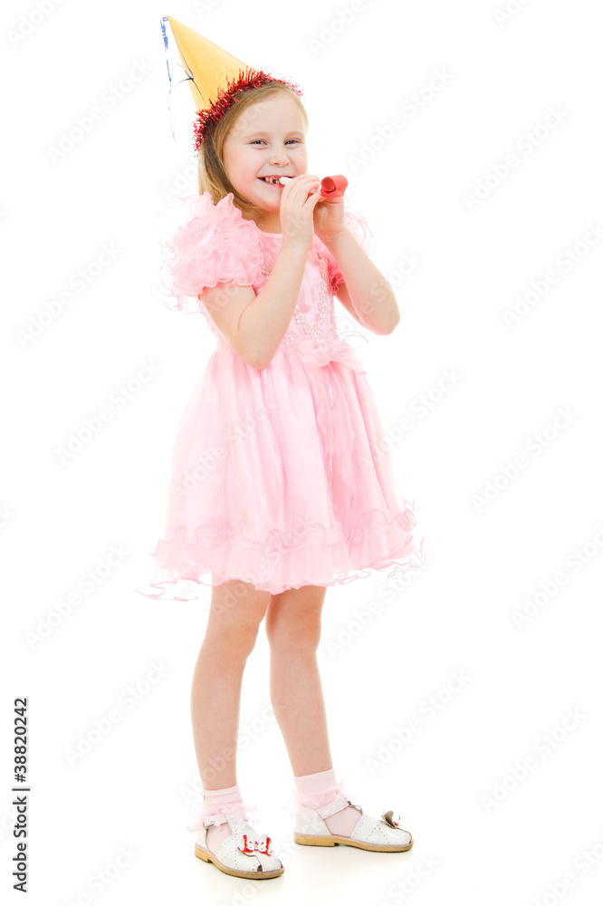 A girl in a pink dress and hat blowing in the pipe A girl in a pink dress and hat blowing in the pipe
