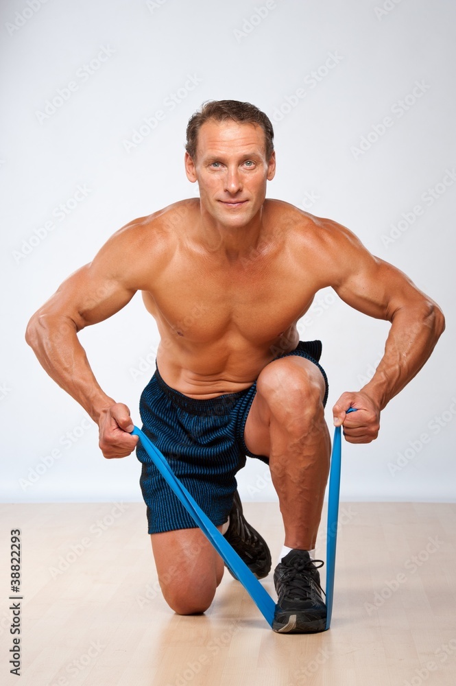 Handsome muscular man doing stretching exercise. Handsome muscular man doing stretching exercise.